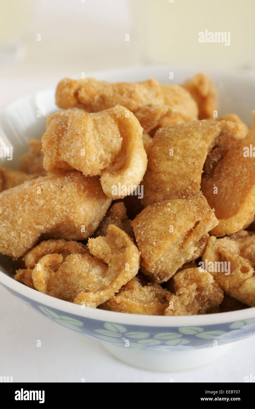 Pork scratchings deep fried pork rinds popular through the world as a