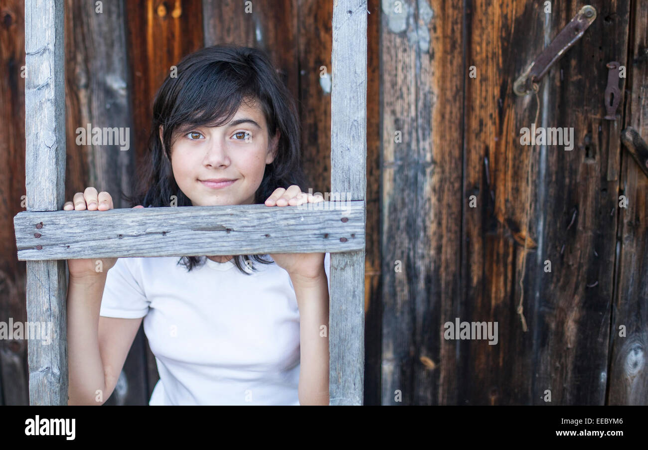 Cute teen girl posing near a house in the village Stock Photo - Alamy