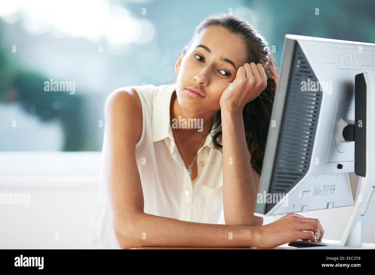 Girl bored at work Stock Photo Alamy