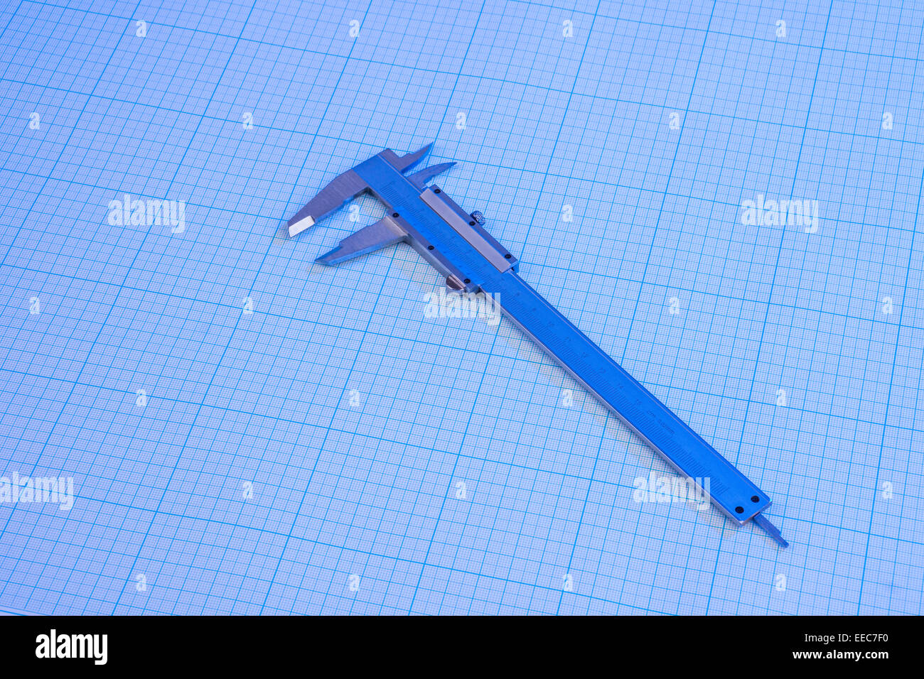 Vernier-caliper on graph paper under blue light Stock Photo