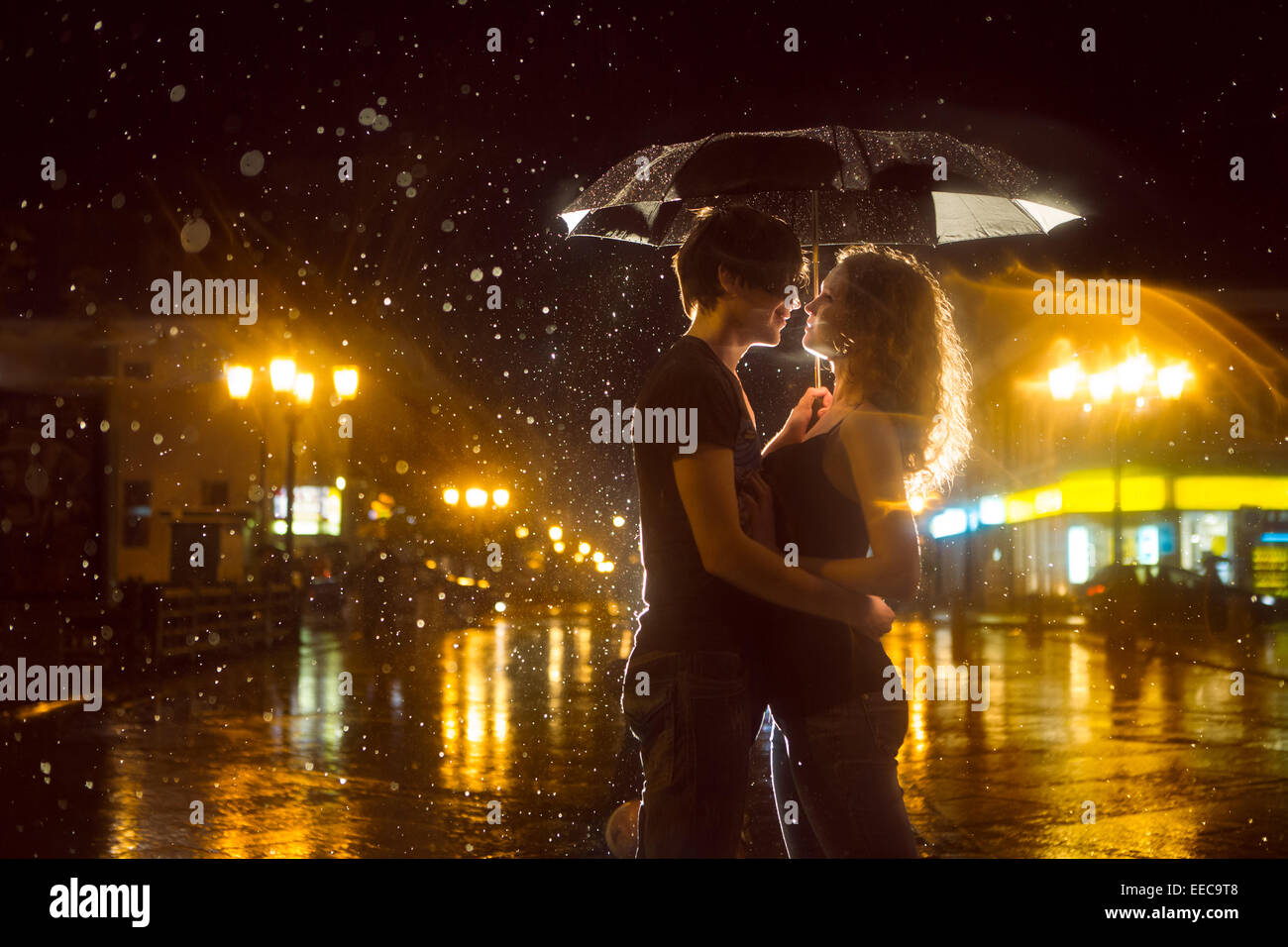The girl with the boy kissing under a rain Stock Photo - Alamy