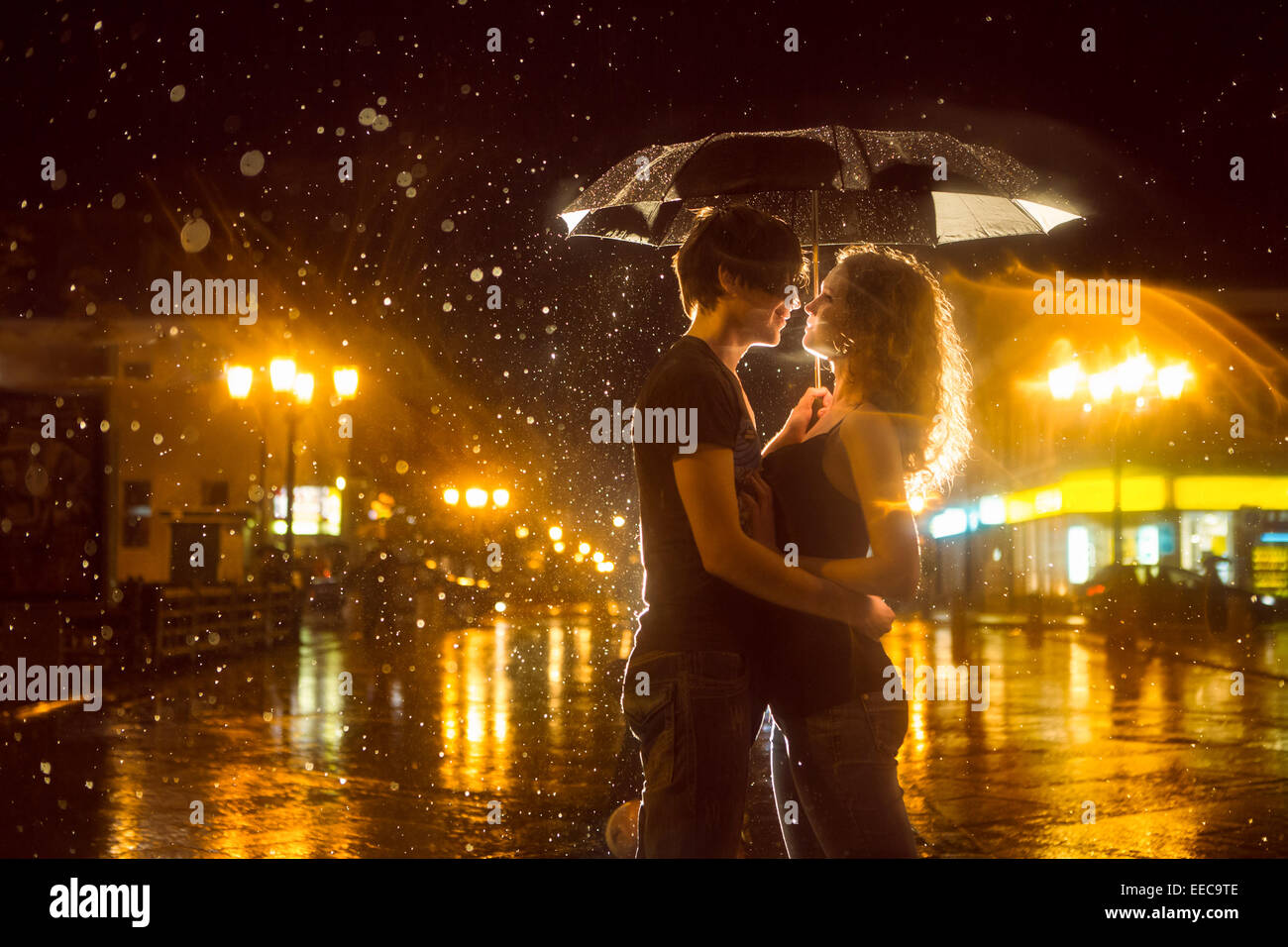 The girl with the boy kissing under a rain Stock Photo Alamy