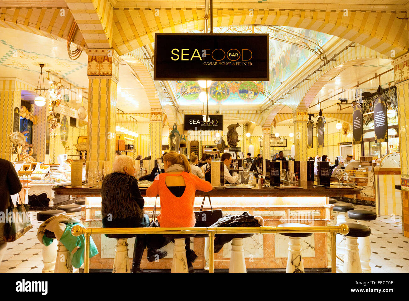 People eating at the Seafood and Sushi Bar, Harrods department store Knightsbridge London; the department in the interior, UK Stock Photo
