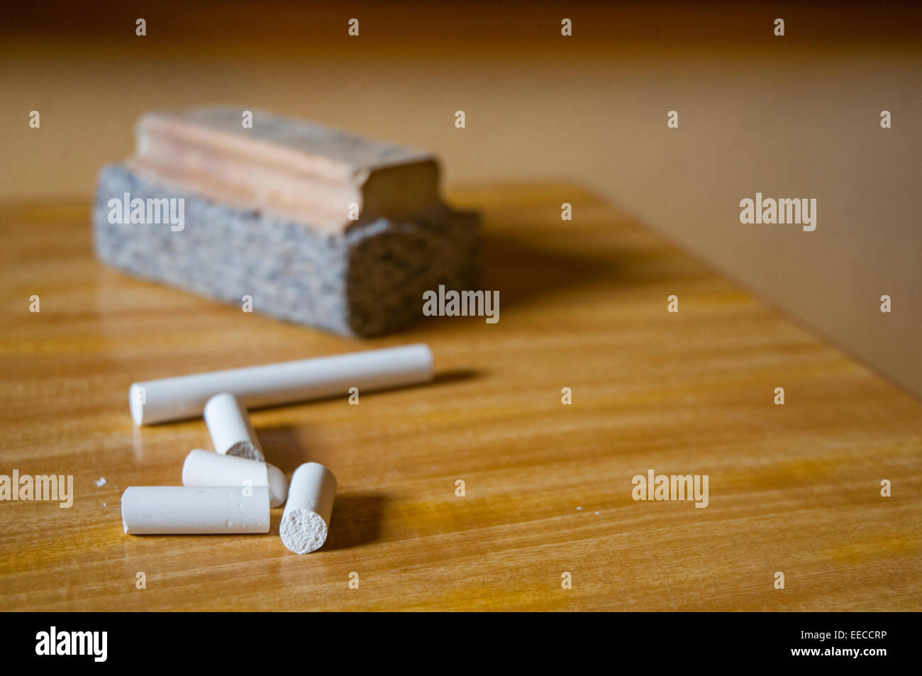 Chalks and board rubber on teacher's table. Close view. Stock Photo