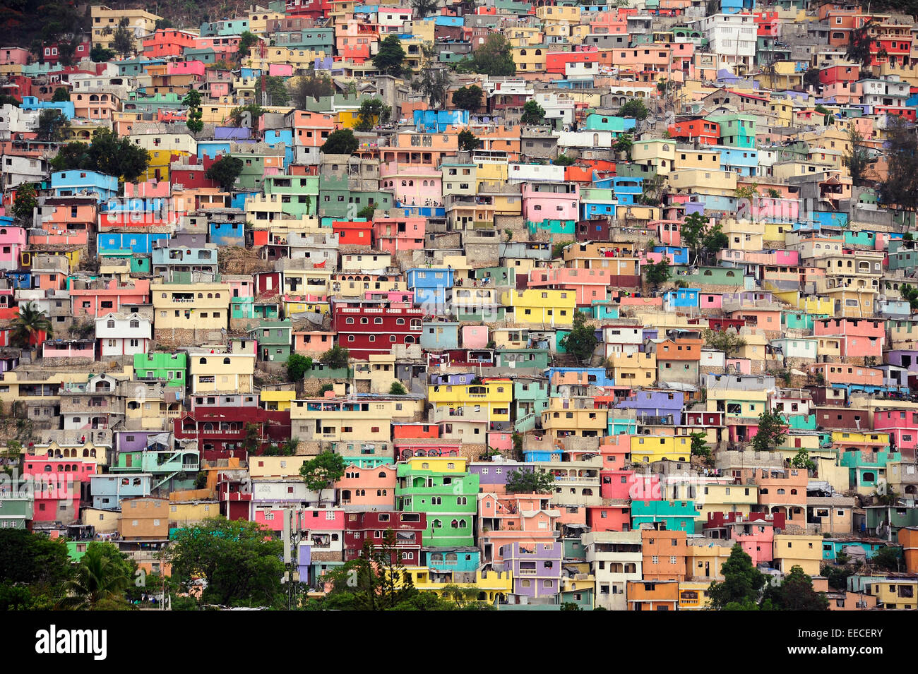 Brightly colored houses stacked on top of one another in the Jalousie slum of Port-au-Prince. The bright colors only mask the is Stock Photo