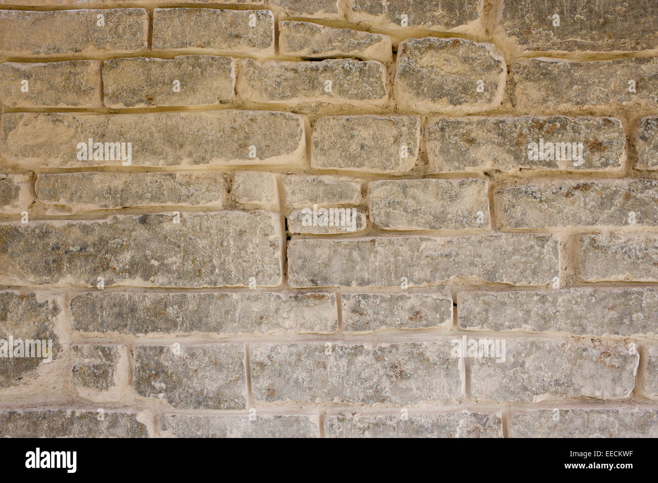 Repointing a Cotswolds stone wall using traditional mortaring method