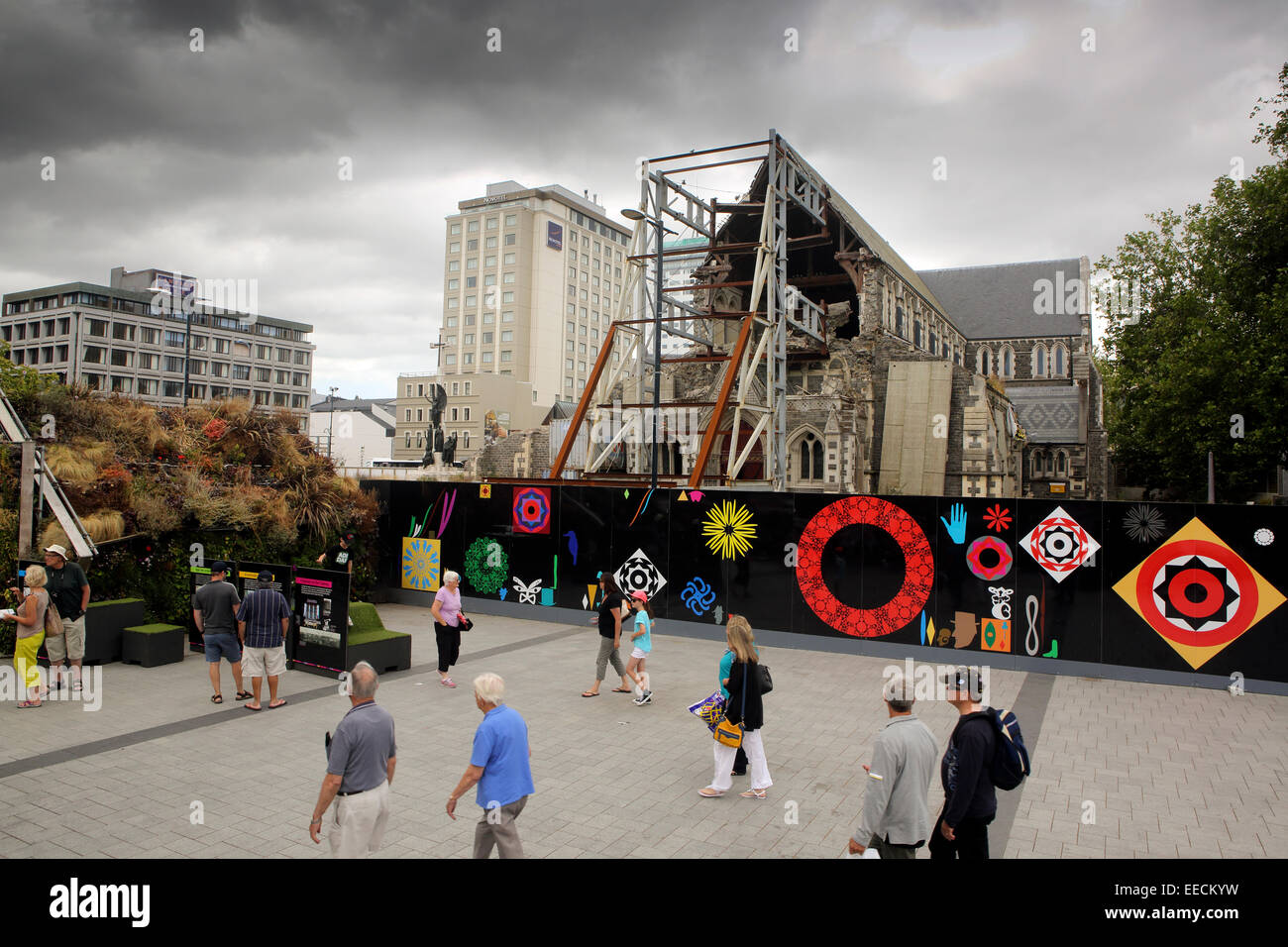 Pedestrians walk past the remains of the Christchurch Cathedral, destroyed on the February 2011 earthquake Stock Photo