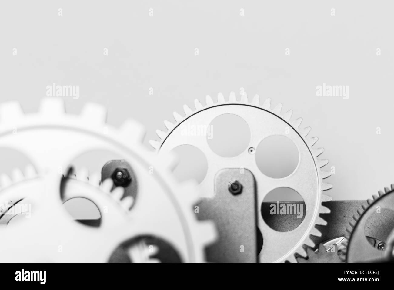 A group of silver gears functioning together in a precision machinery Stock Photo