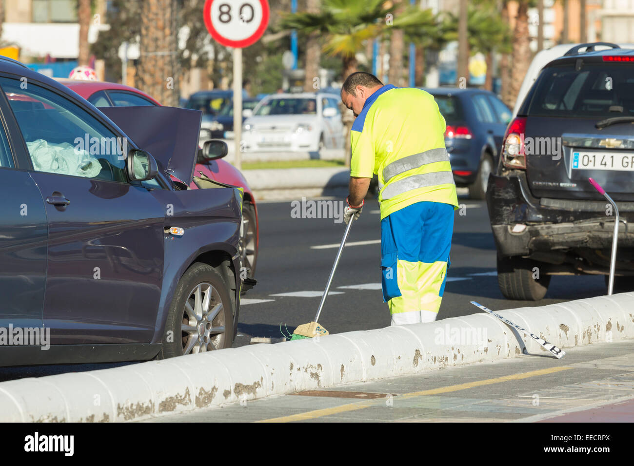 Council worker sweeping glass off road following traffic accident on Gran Canaria, Canary Islands, Spain Stock Photo