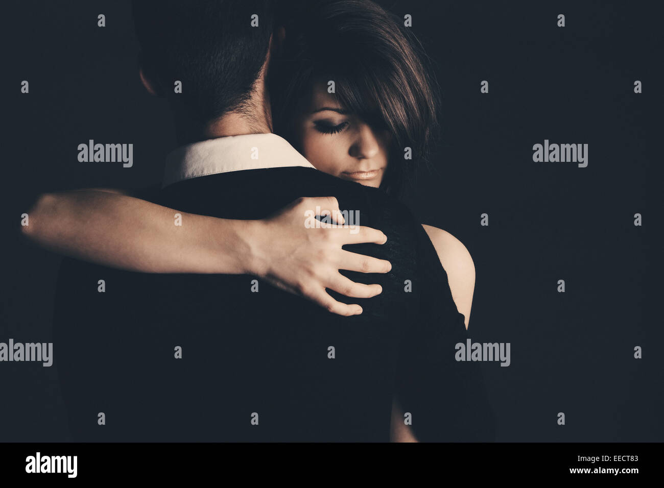 Low Key Shot of a Young Couple Embracing Stock Photo