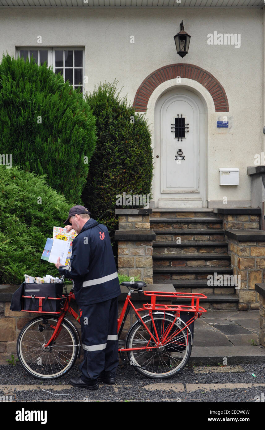 Belgian Postman at work with its business cycle Stock Photo