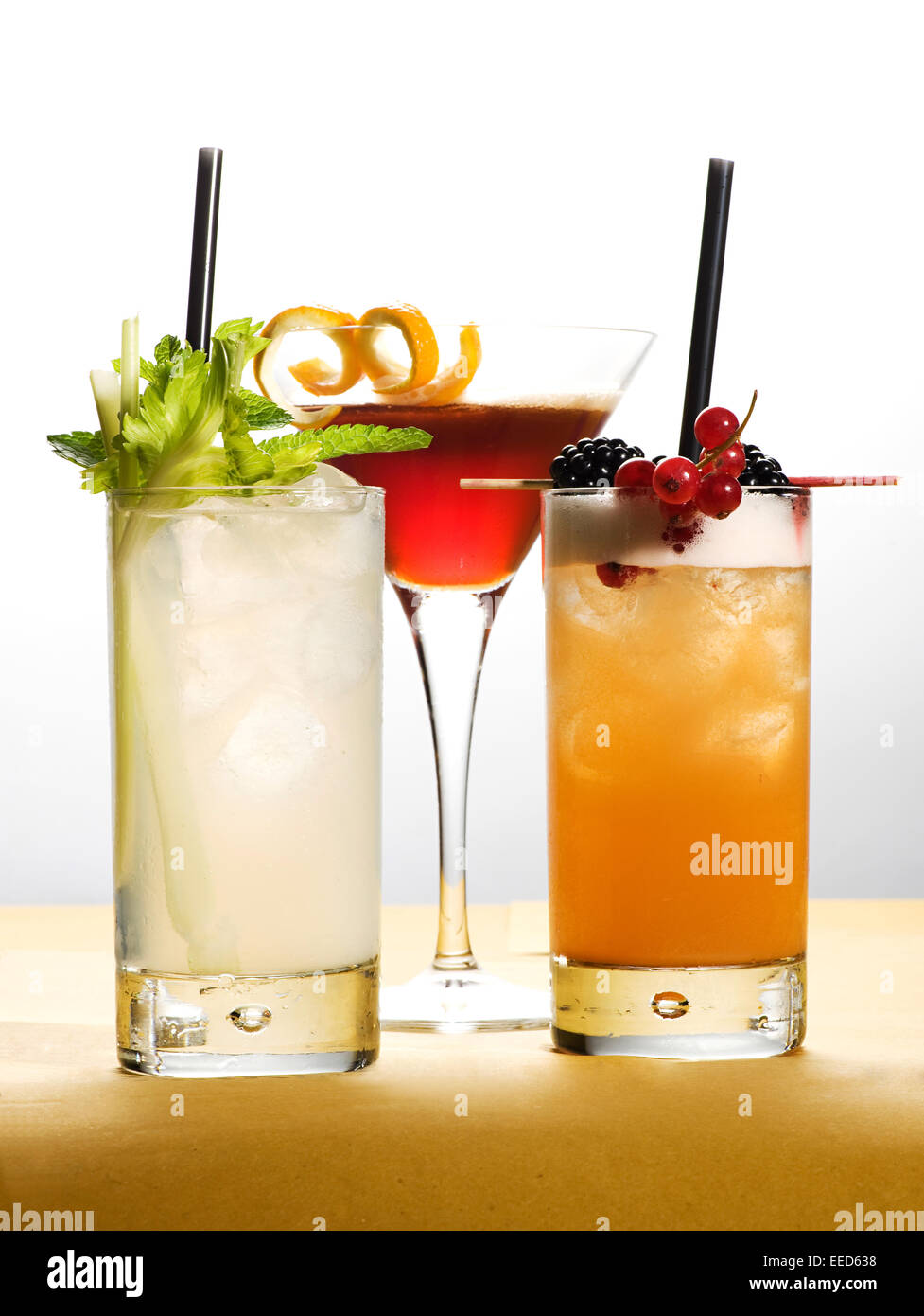Different Drinks on Glasses with Fruits and Leaves Stock Photo