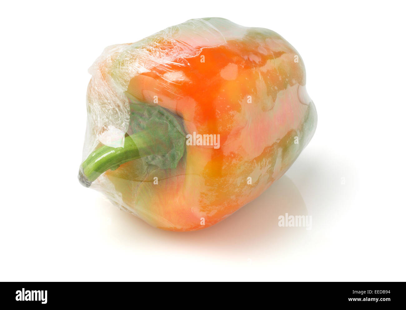 Fresh Pepper Wrapped In Cellophane Film On White Background Stock Photo