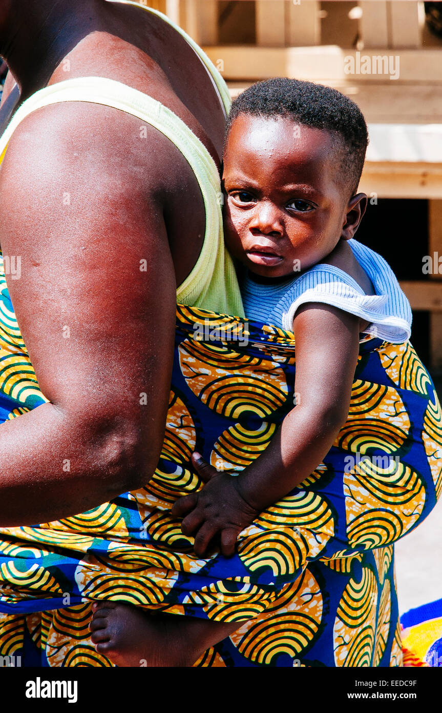 Baby carried on back by his mother. Lomé, Togo Stock Photo