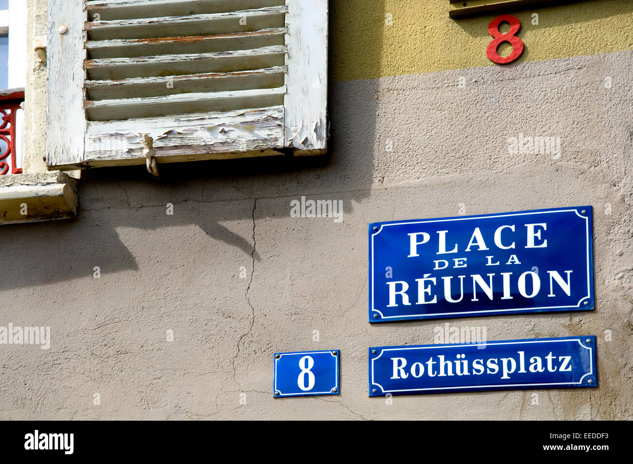 Mulhouse, Alsace, France. Bilingual Street Signs (French and Alsace German) Place de la Reunion Stock Photo