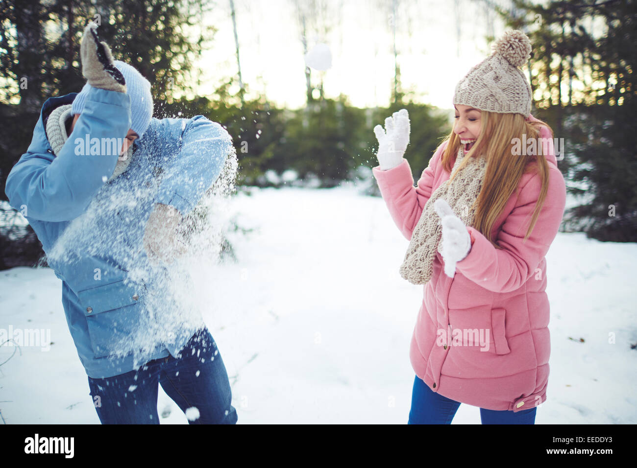 Happy young dates playing snowballs outdoors Stock Photo - Alamy