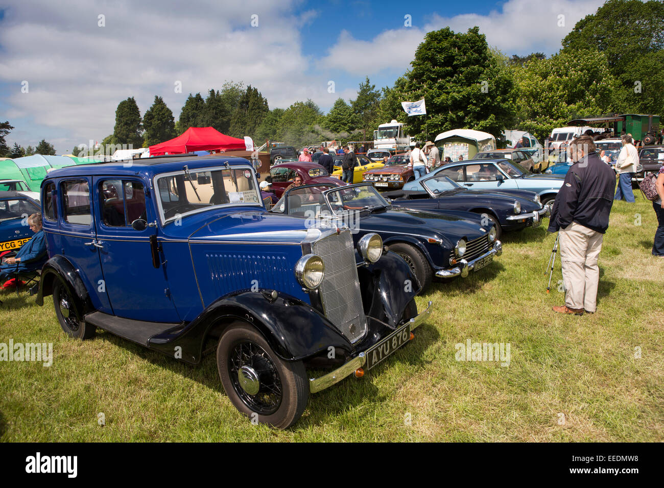 UK, England, Wiltshire, Steam and Vintage Fair, visitor admiring 1936 Vauxhall 21-6 and Triumph TR5 Stock Photo