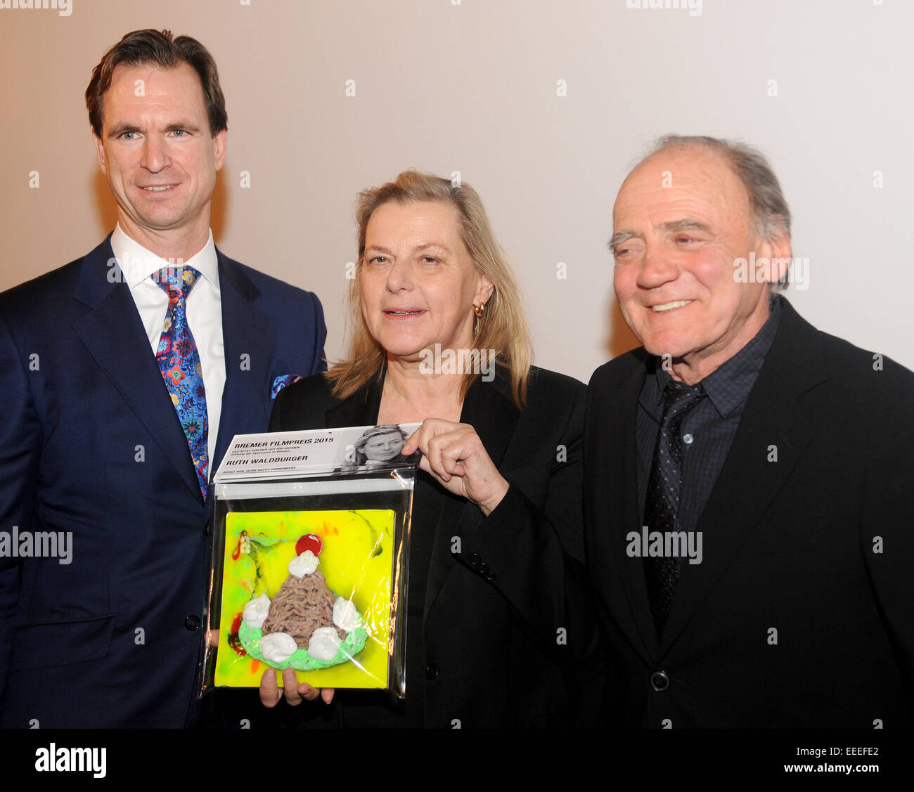 Bremen, Germany. 15th Jan, 2015. Swiss actor and eulogist of the Bremen Film Prize award, Bruno Ganz (R), the chairman of the board of Sparkasse Bremen, Tim Nesemann (L) and award winner and Swiss producer Ruth Waldburger stand together after the award ceremony for the Bremen Film Prize in the town hall of Bremen, Germany, 15 January 2015. The Bremen Film Prize is endowed with 8,000 euro sponsored by the Sparkasse Bremen Foundation. Bruno Ganz was the first ever awardee to be honoured with the Bremen Film Prize. Photo: Ingo Wagner/dpa/Alamy Live News Stock Photo