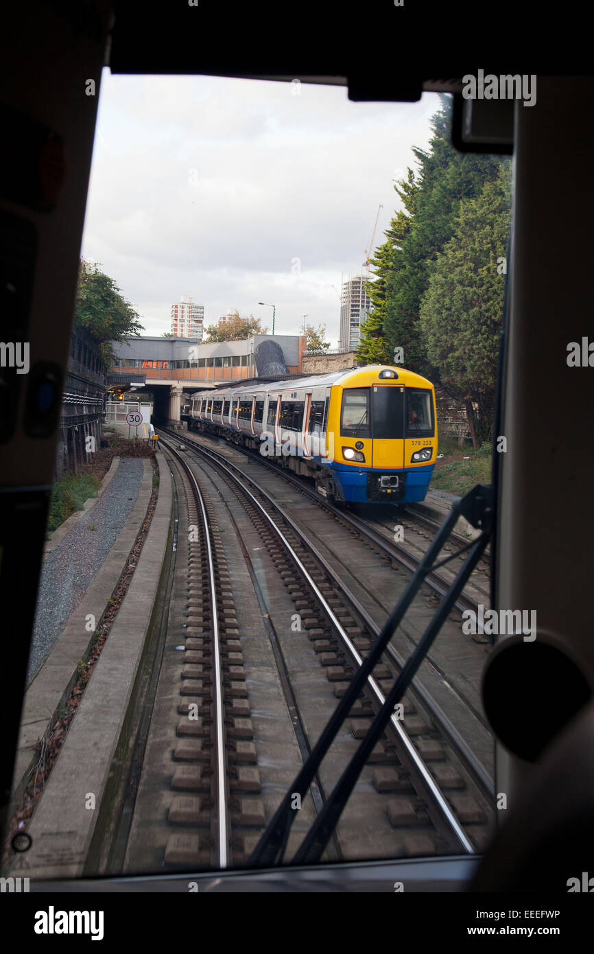 Driver's view on the approach to Surrey Quays with an oncoming train Stock Photo