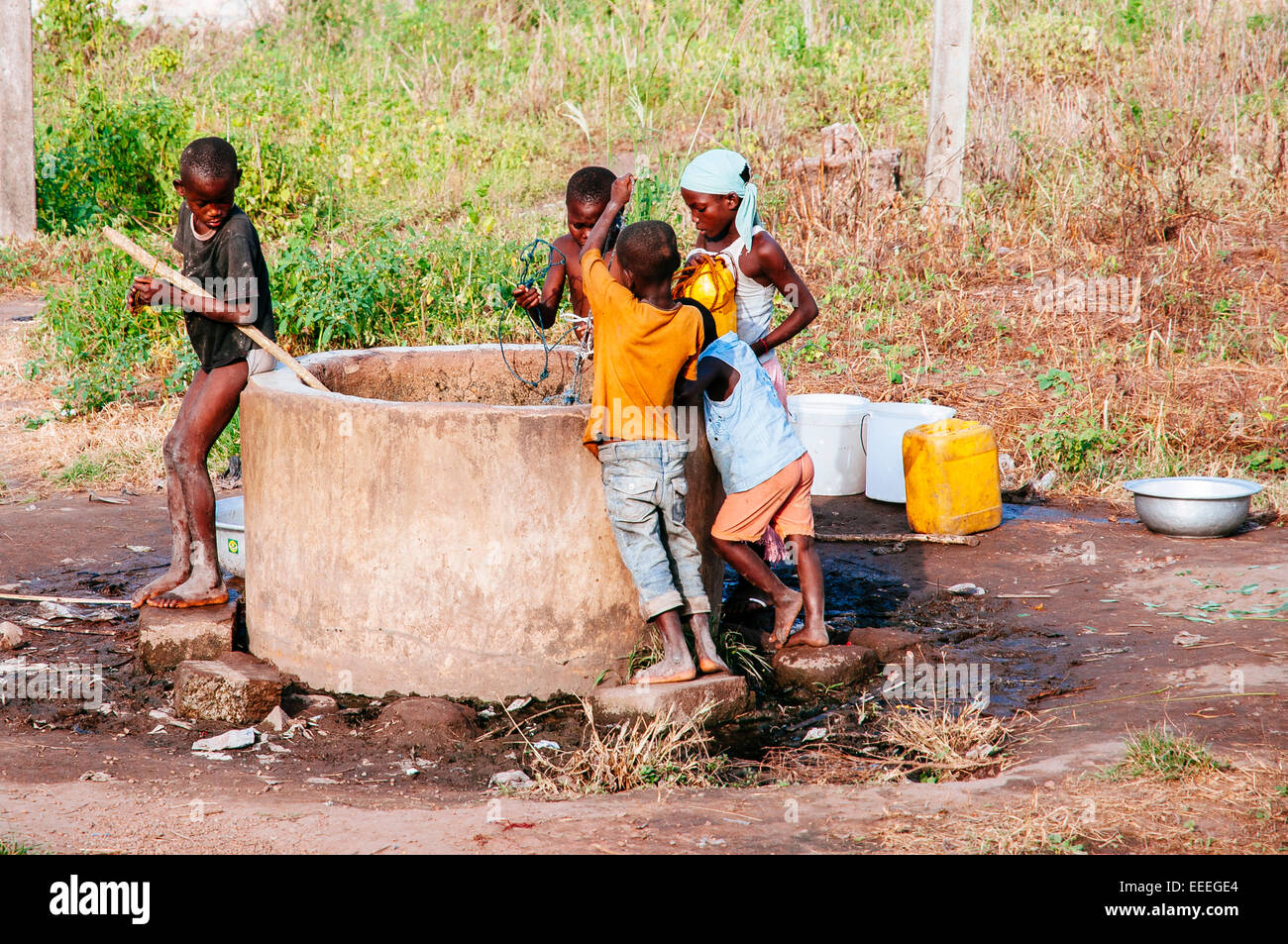 Children collecting water from a well, Ghana Stock Photo