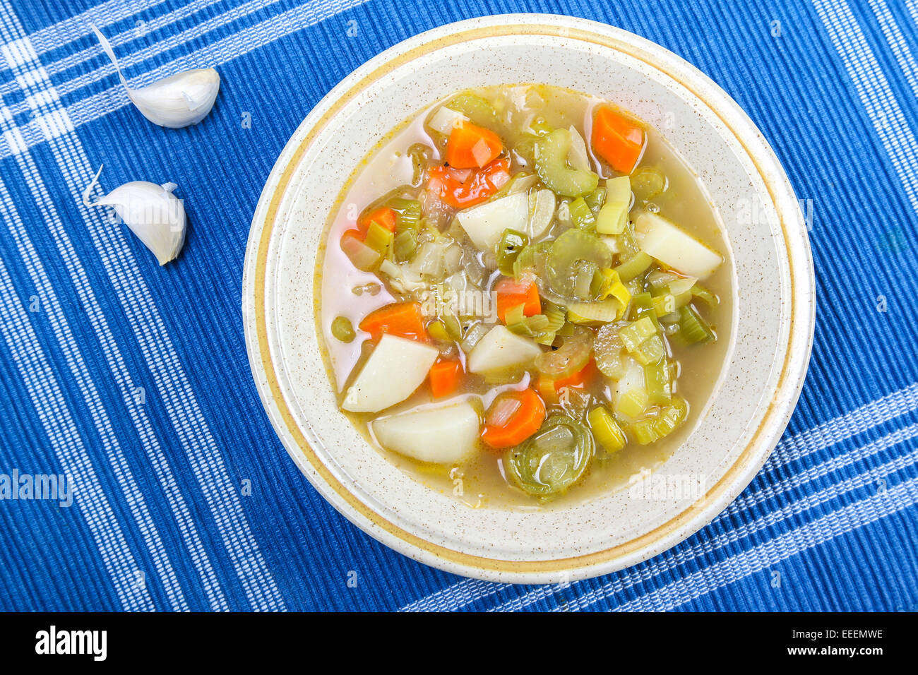 Leek soup with potato on blue background with garlic Stock Photo Alamy