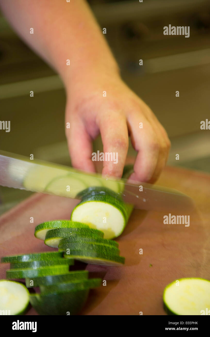 A chef chopping courgettes Stock Photo