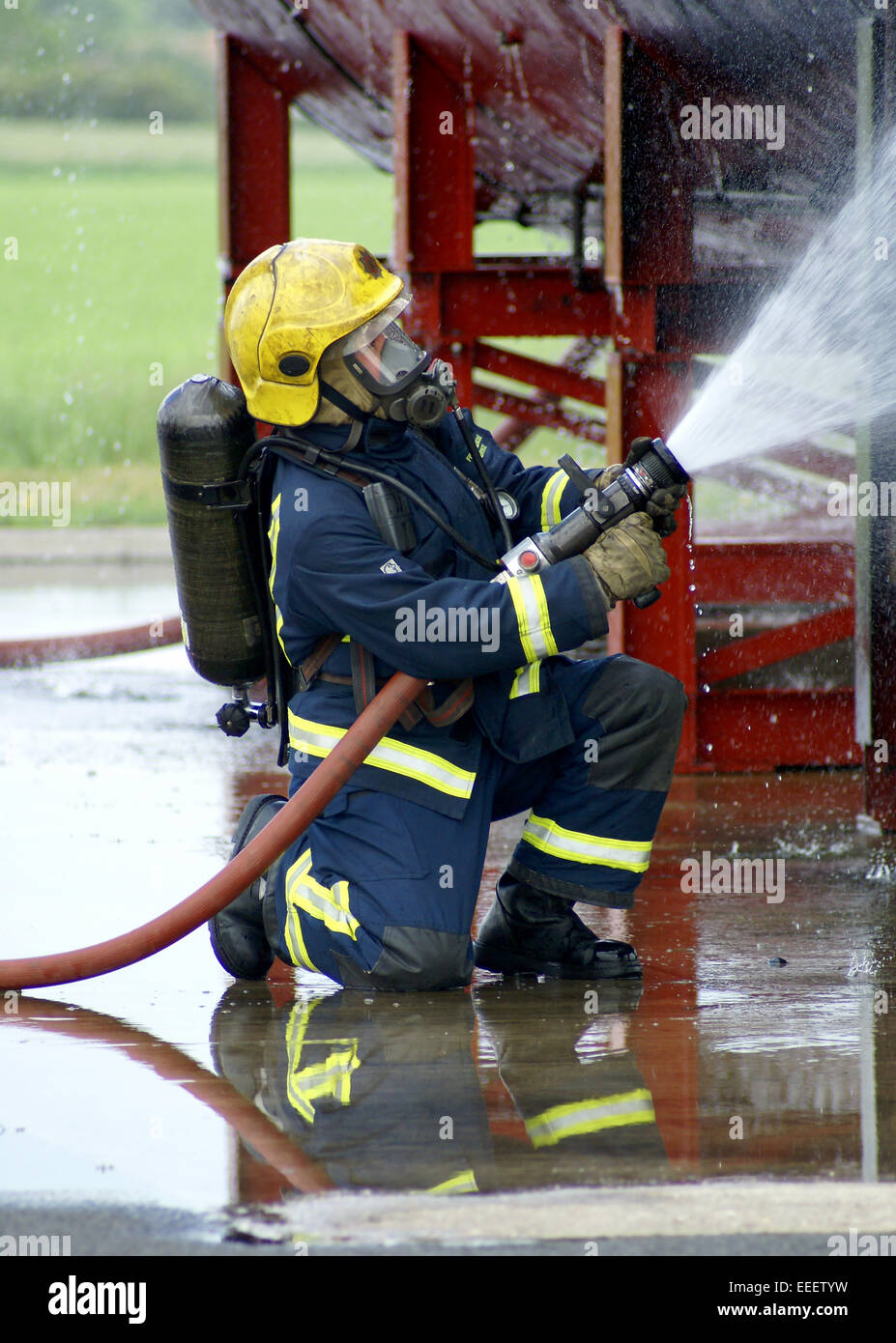 firefighter fighting fire with hose