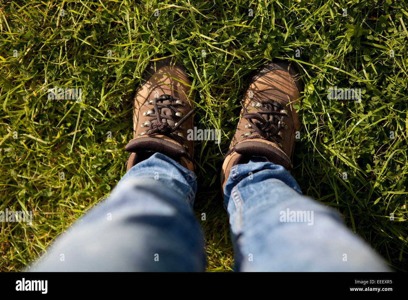 First-person point of view photo of feet wearing lace-up walking boots ...