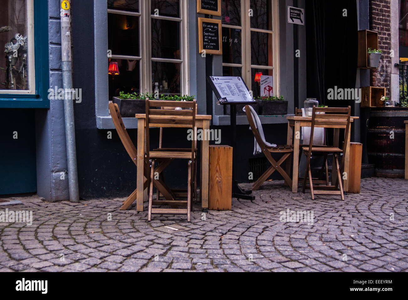 Table and chairs near a bar on the streets of Maastricht, Limburg, The Netherlands Stock Photo
