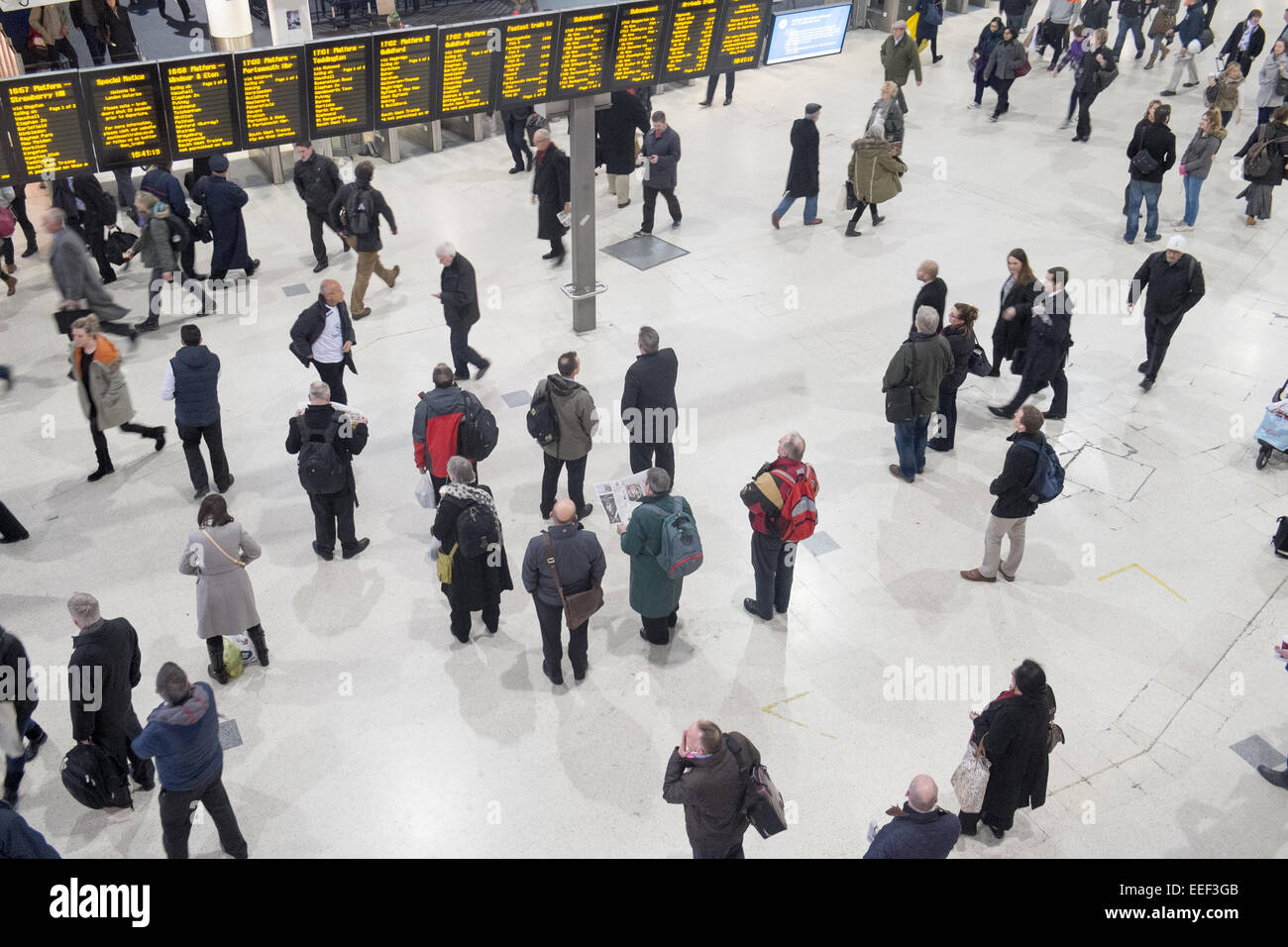 london waterloo railway station and passengers on the concourse,england with departure boards displaying train times Stock Photo