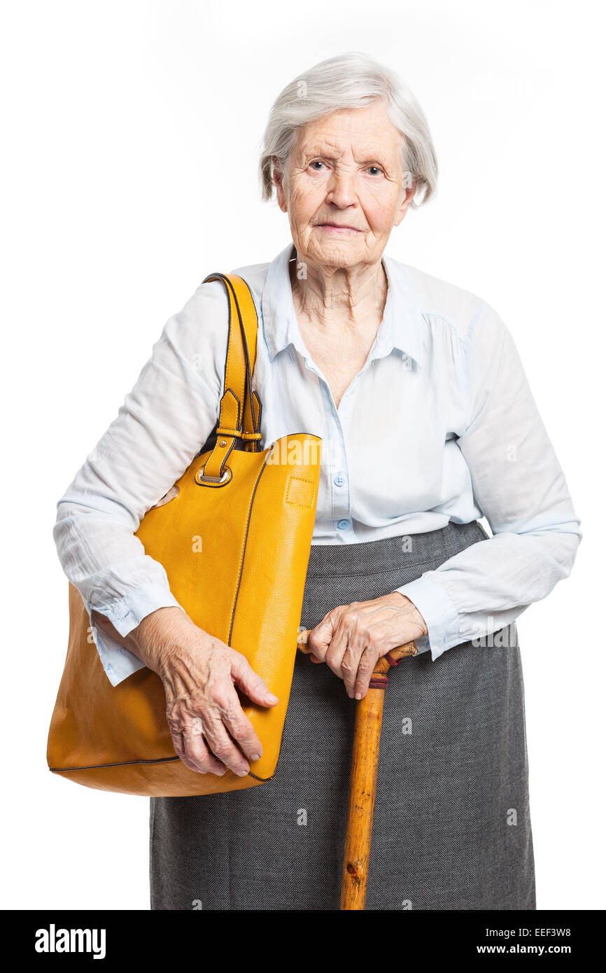 Elegant senior woman with walking stick standing over white Stock Photo ...