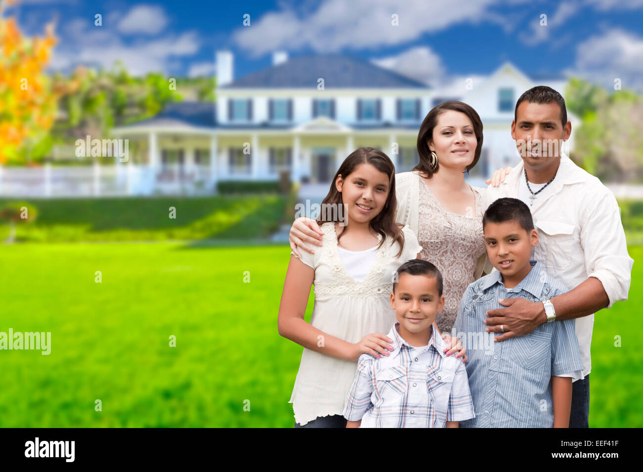 Happy Young Hispanic Family in Front of Their New Home Stock Photo - Alamy