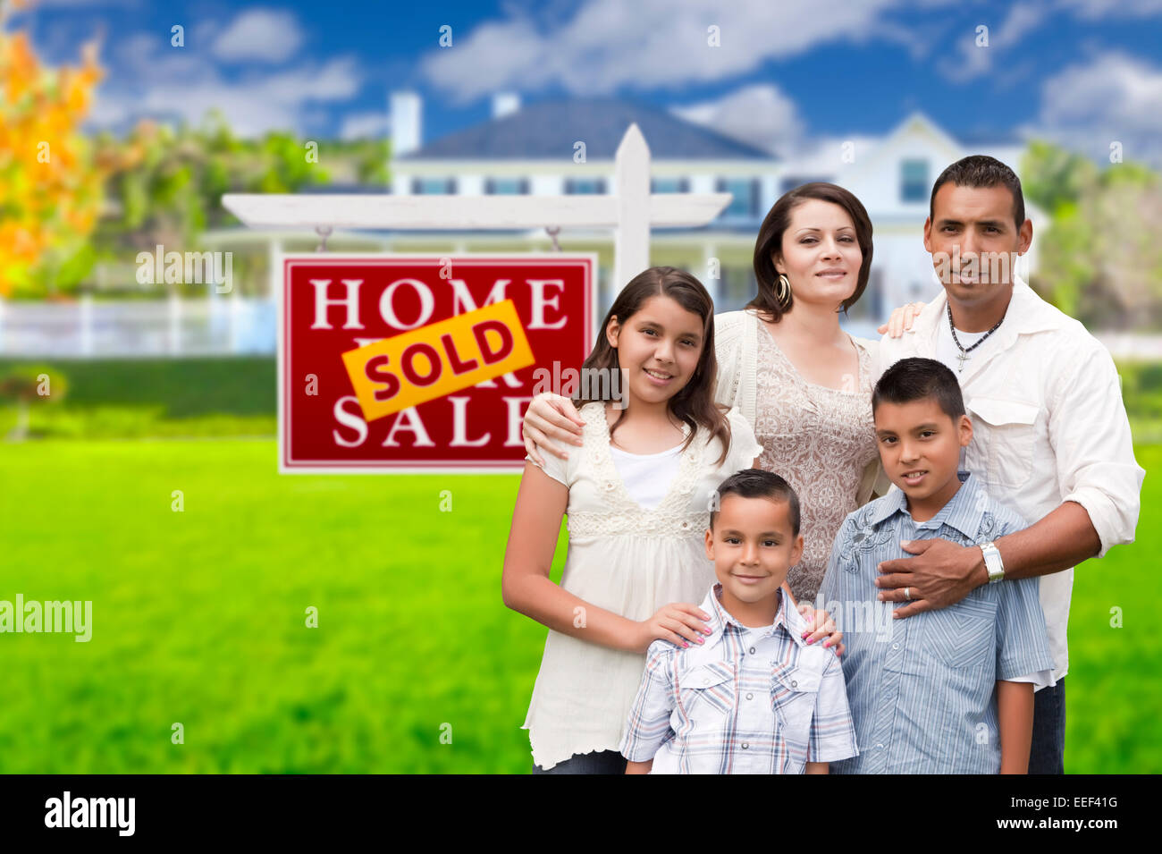 Happy Hispanic Family in Front of Their New House and Sold Home For Sale  Real Estate Sign Stock Photo - Alamy