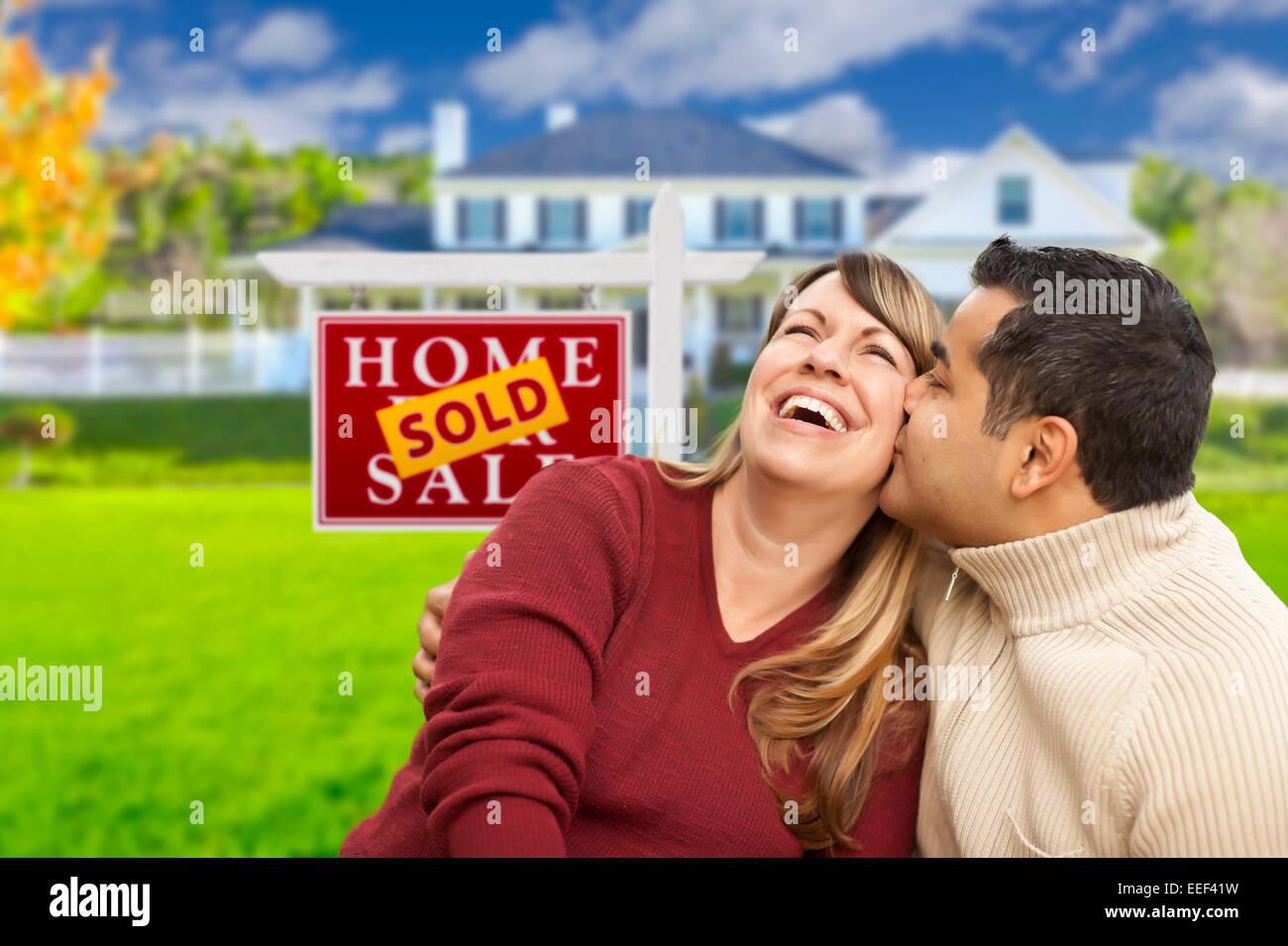 Happy Mixed Race Couple in Front of Sold Real Estate Sign Stock Photo ...