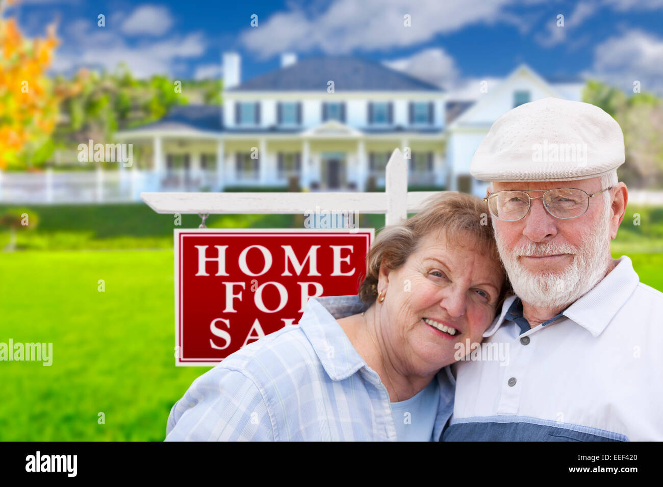 Happy Senior Couple Front of For Sale Real Estate Sign and House Stock ...