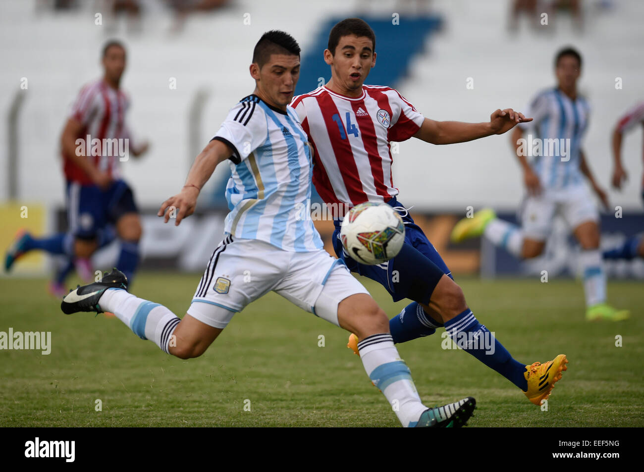 Colonia, Uruguay. 16th Jan, 2015. Player Cristian Espinoza (L) of Argentina vies the ball with Jose Sanabria of Paraguay during the match of the South american U20 tournament, held in the Alberto Supici Stadium, in Colonia, 200km away of Montevideo, capital of Uruguay, on Jan. 16, 2015. Credit:  Nicolas Celaya/Xinhua/Alamy Live News Stock Photo