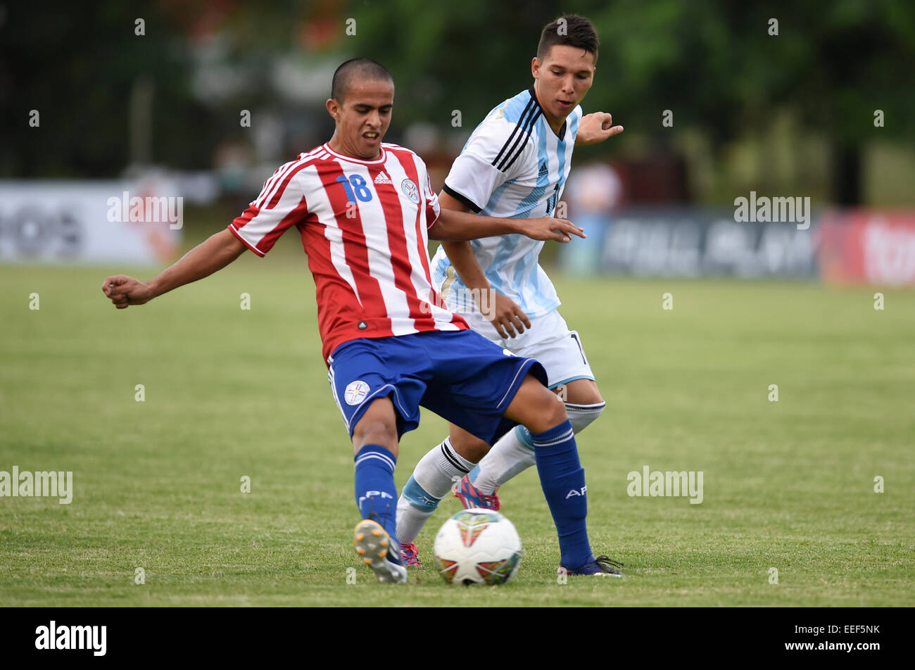 Colonia, Uruguay. 16th Jan, 2015. Player Tomas Martinez (R) of Argentina vies the ball with Enrique Araujo of Paraguay during the match of the South american U20 tournament, held in the Alberto Supici Stadium, in Colonia, 200km away of Montevideo, capital of Uruguay, on Jan. 16, 2015. Credit:  Nicolas Celaya/Xinhua/Alamy Live News Stock Photo