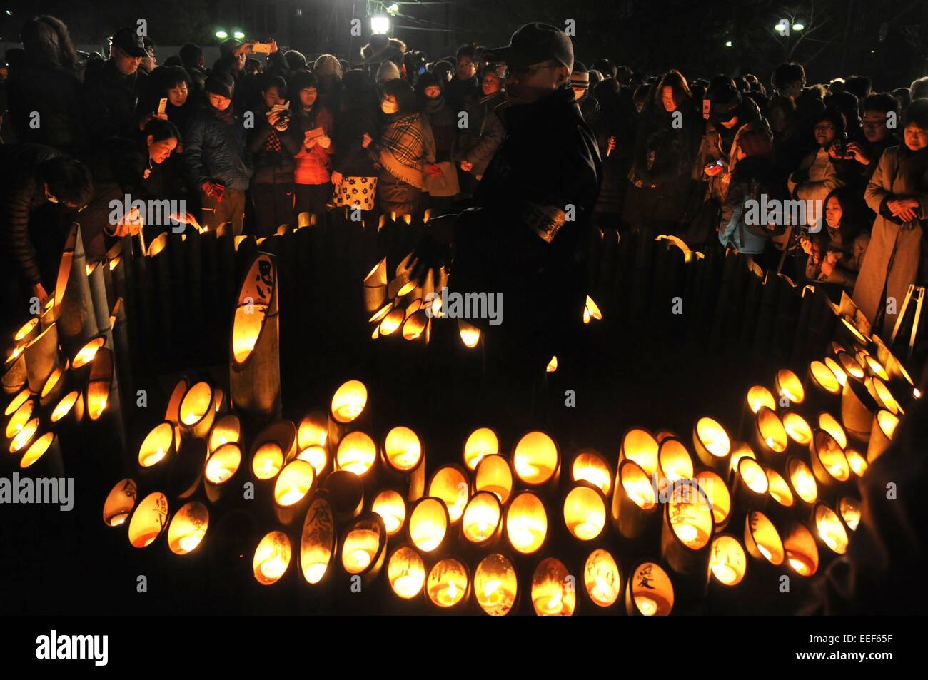 Kobe, Japan. 17th Jan, 2015. People light candles for the victims of the Great Hanshin Earthquake during a ceremony to mark the 20th anniversary of the earthquake in Kobe, western Japan, early January 17, 2015. More than 14,000 people gathered in Japan's Kobe on Friday morning to pray for the souls of the 6,434 victims of the 1995 Great Hanshin Earthquake. Credit:  Ma Xinghua/Xinhua/Alamy Live News Stock Photo