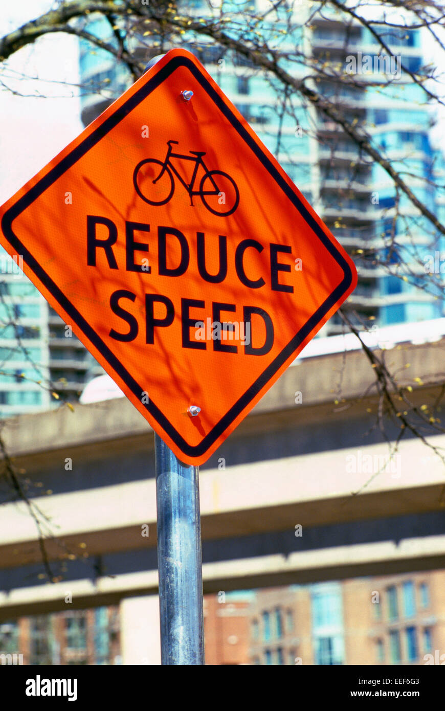 Warning Caution Road Sign - Reduce Speed, Bicycle Stock Photo