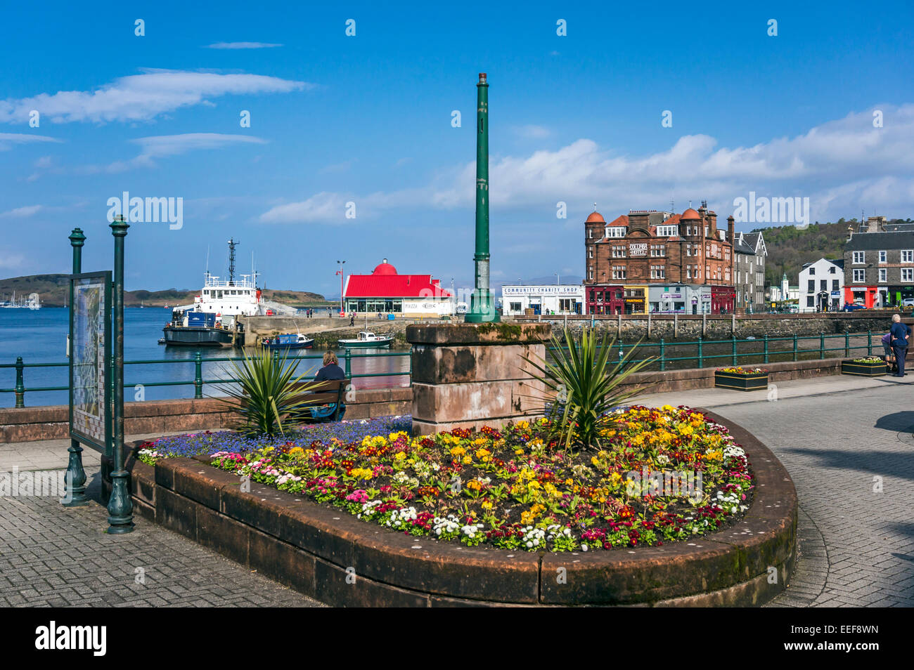 Flower arrangement on the promenade in Oban harbour area Scotland with vessel moored at the North pier Stock Photo