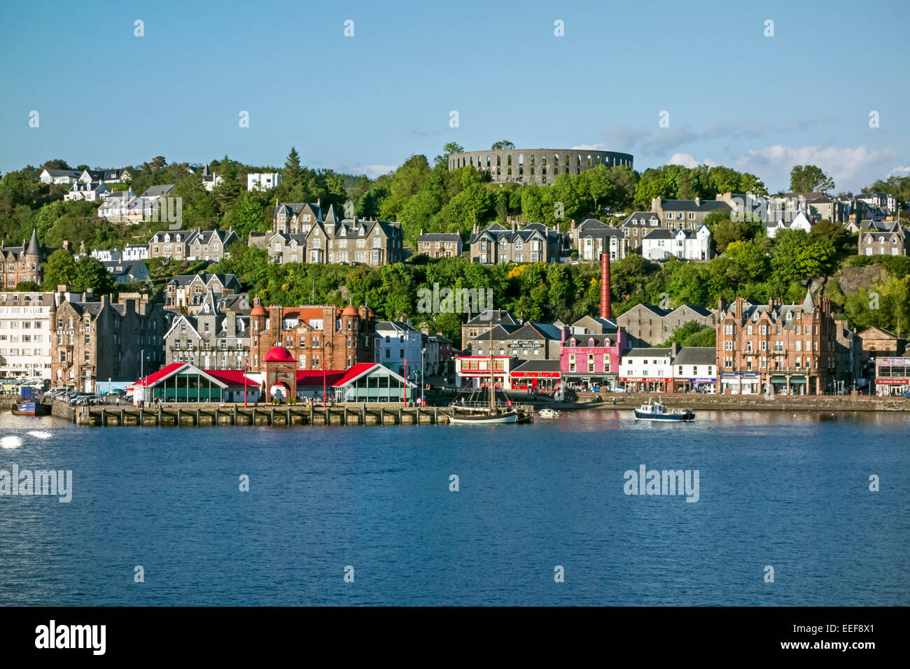 The North Pier in Oban Scotland seen from Oban Bay with McCaig's Tower top right Stock Photo