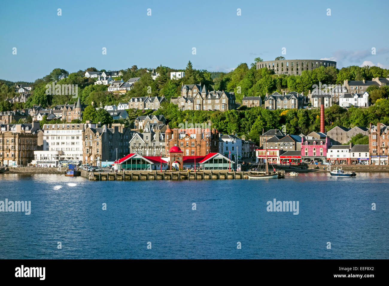The North Pier in Oban Scotland seen from Oban Bay with McCaig's Tower top right Stock Photo