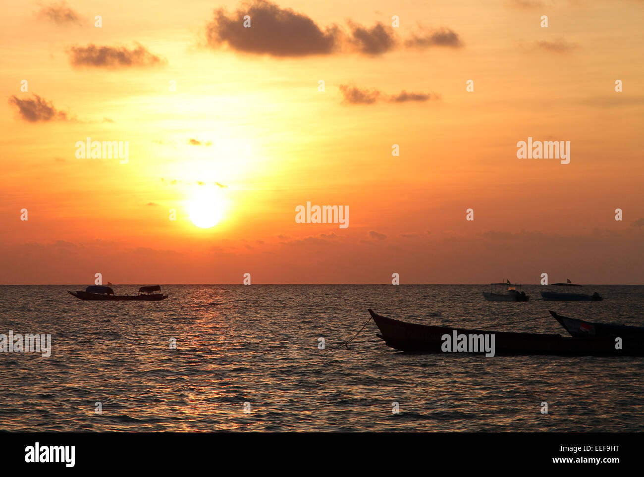Sunrise and small boats Stock Photo
