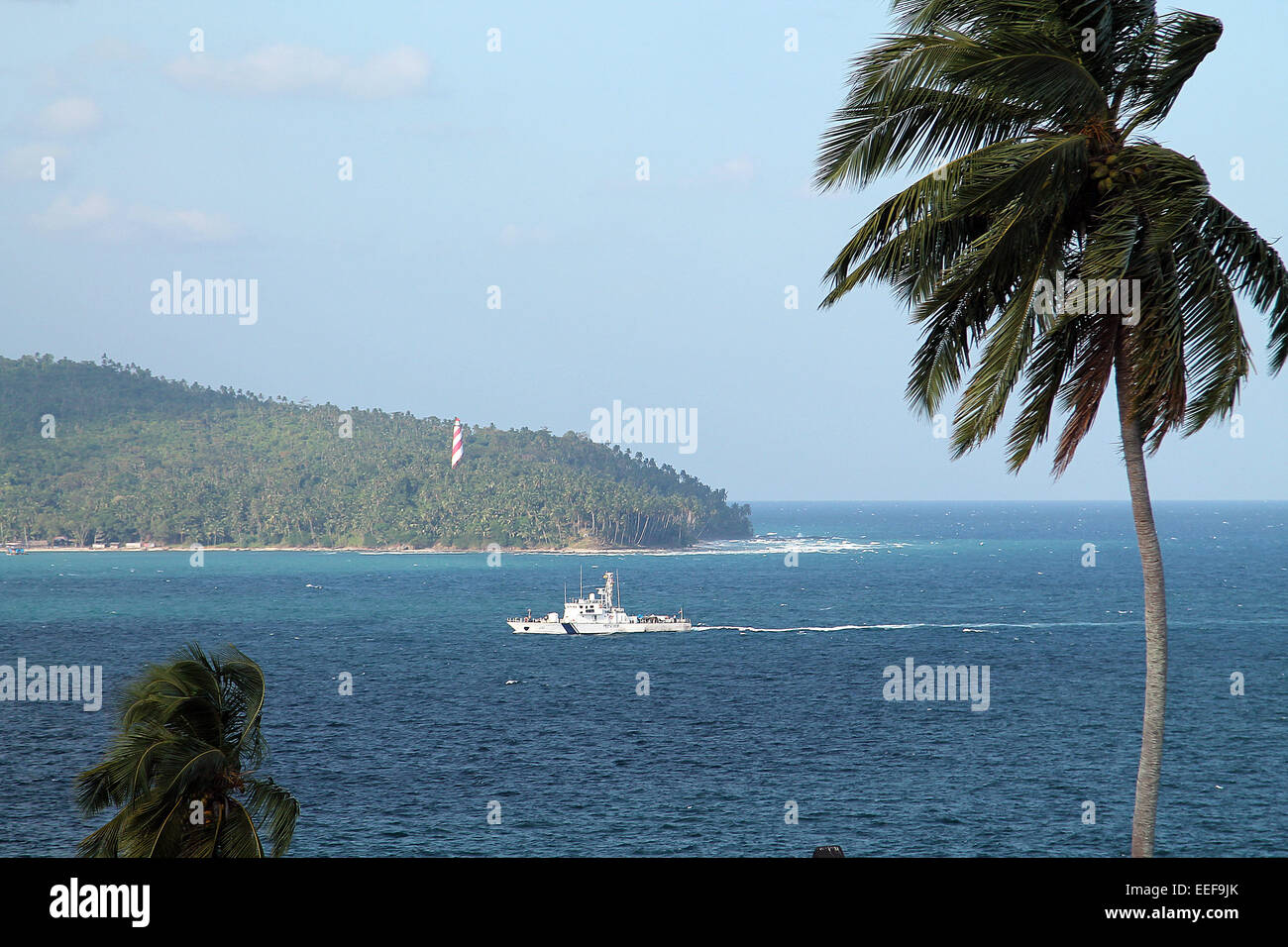 PORT BLAIR - 31 DECEMBER: An Indian coast guard ship returns to Port Blair from an exercise on december 31, 2014 in the Andaman and Nicobar islands. Stock Photo