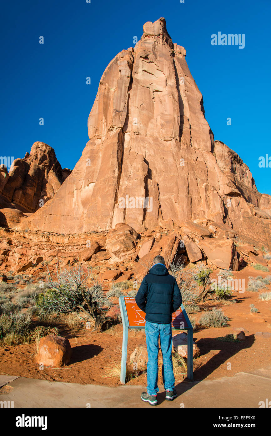 Caucasian male tourist reading an information sign, Arches National Park, Utah, USA Stock Photo