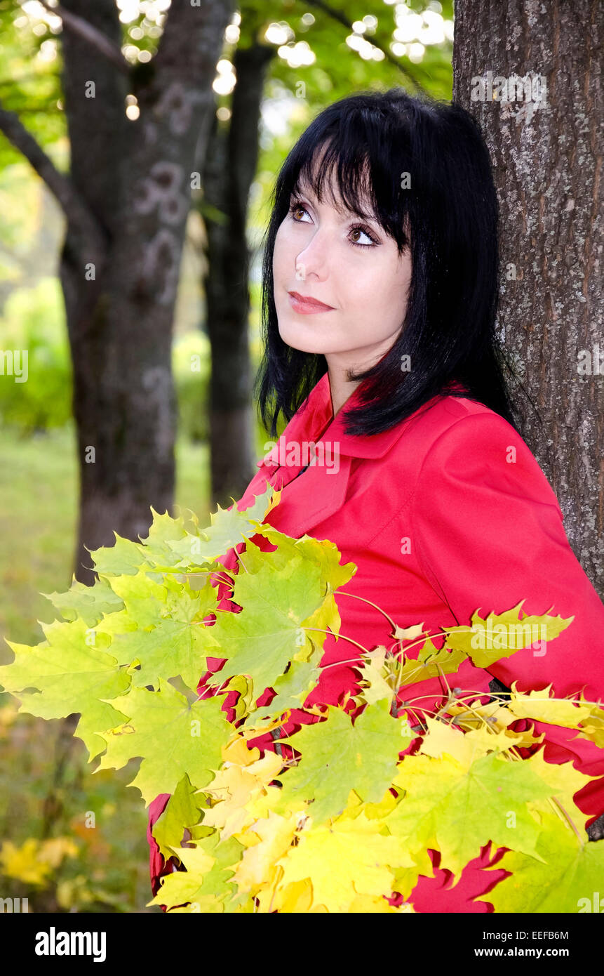 The girl walks in the Park with a bouquet of yellow maple leaves Stock ...