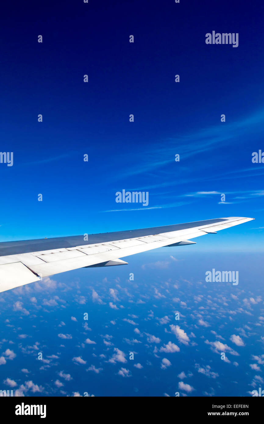 View from window of sky and aeroplane wing over cloud Stock Photo