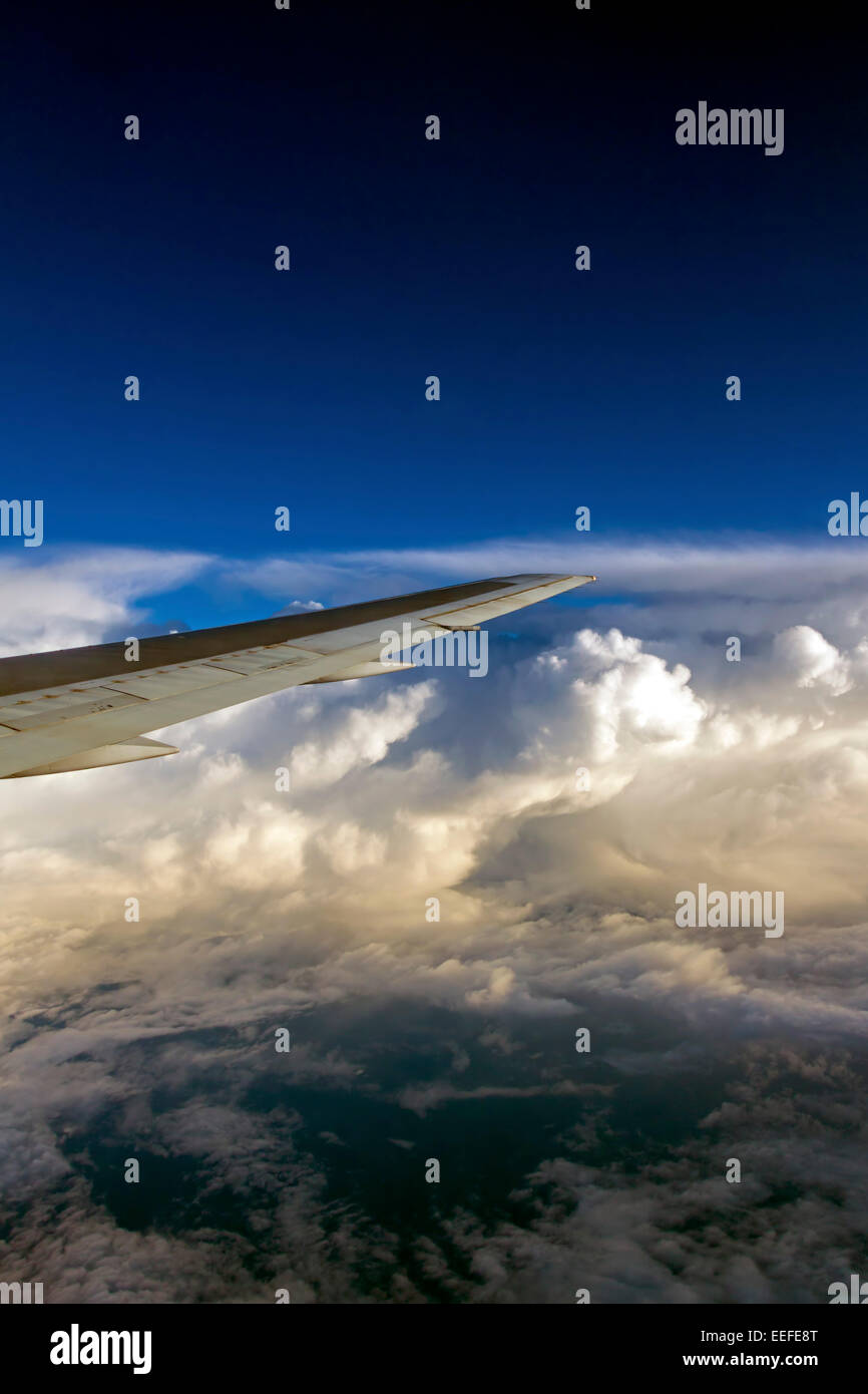 View from window of sky and aeroplane wing over cloud Stock Photo