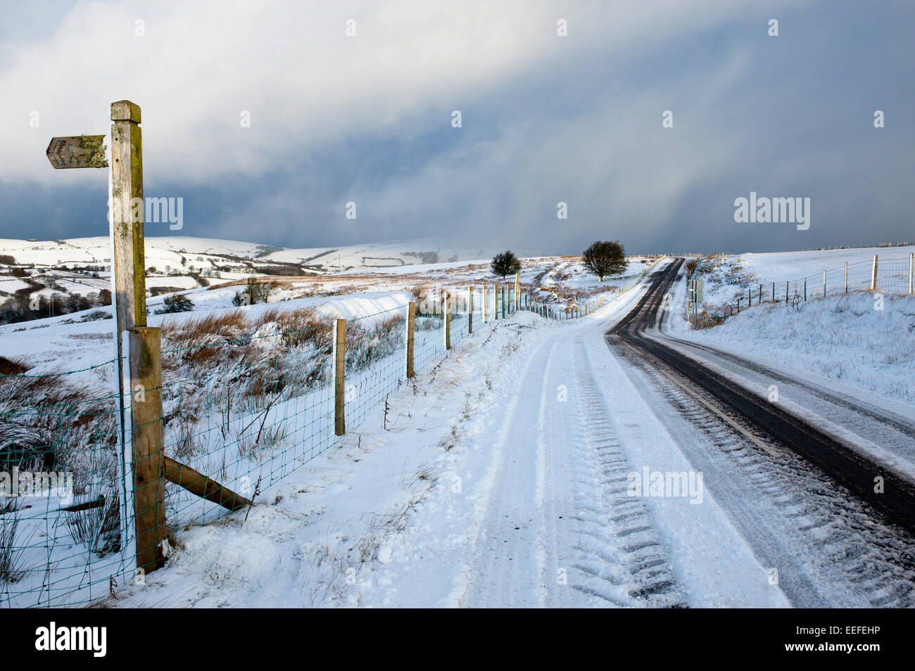 Mynydd Epynt, Powys, UK. 17th January, 2015. The B4520 'Brecon Road' between Brecon and Builth Wells has been cleared by the gritter truck. There was an overnight snowfall on high land in Mid-Wales. Credit:  Graham M. Lawrence/Alamy Live News. Stock Photo