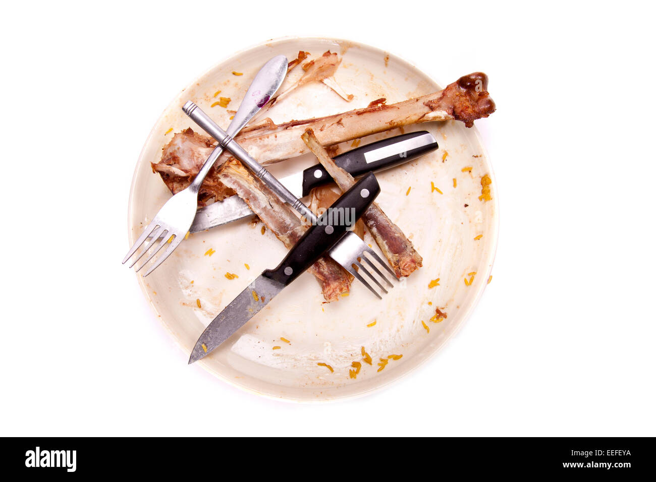 A stack of dirty plates, forks, knifes and a glass that needs washing-up. Dirty dishes. Stock Photo
